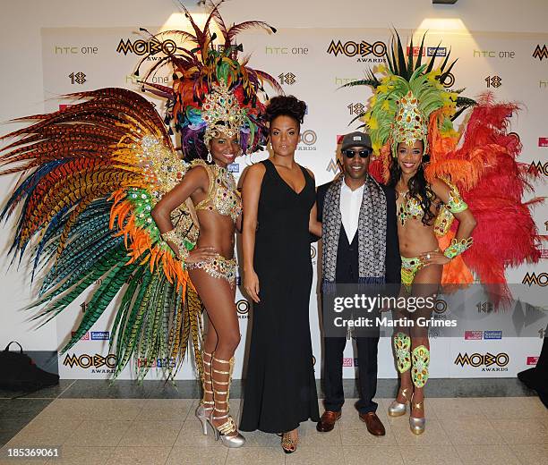 Miss Dynamite and Shy FX pose at the 18th anniversary MOBO Awards with carvinal dancers at The Hydro on October 19, 2013 in Glasgow, Scotland.