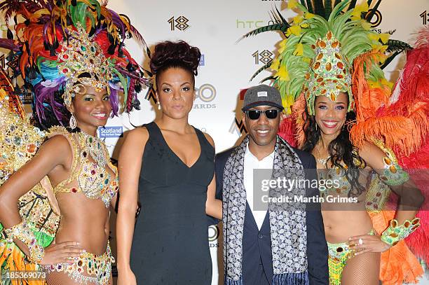 Miss Dynamite and Shy FX pose at the 18th anniversary MOBO Awards with carvinal dancers at The Hydro on October 19, 2013 in Glasgow, Scotland.