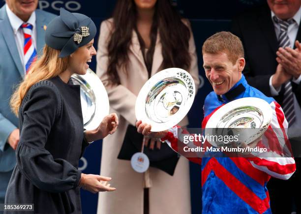 Princess Beatrice presents jockey Johnny Murtagh with the prize for winning the QIPCO British Champions Long Distance Cup as she attends the QIPCO...