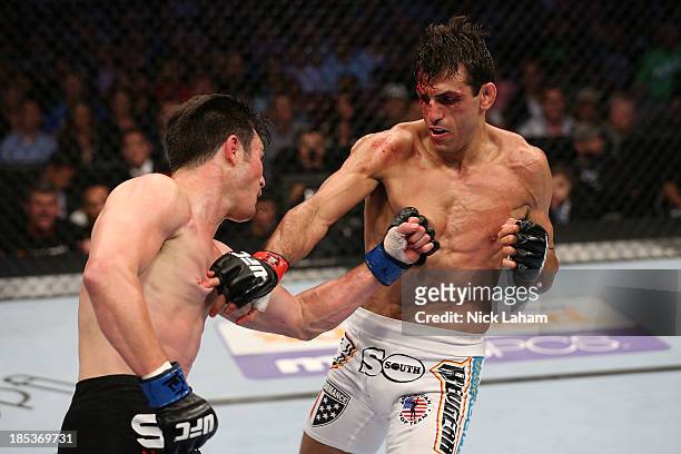 Noons and George Sotiropoulos exchange punches in their UFC lightweight bout at the Toyota Center on October 19, 2013 in Houston, Texas.