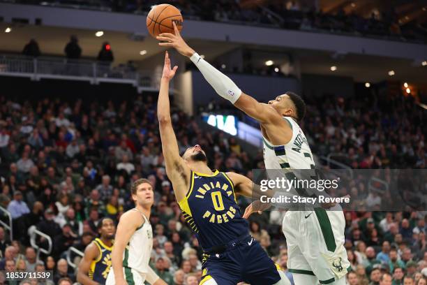 Giannis Antetokounmpo of the Milwaukee Bucks blocks a shot by Tyrese Haliburton of the Indiana Pacers during the first half of a game at Fiserv Forum...