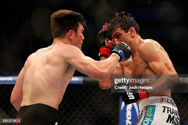 Noons punches George Sotiropoulos in their UFC lightweight bout at the Toyota Center on October 19, 2013 in Houston, Texas.