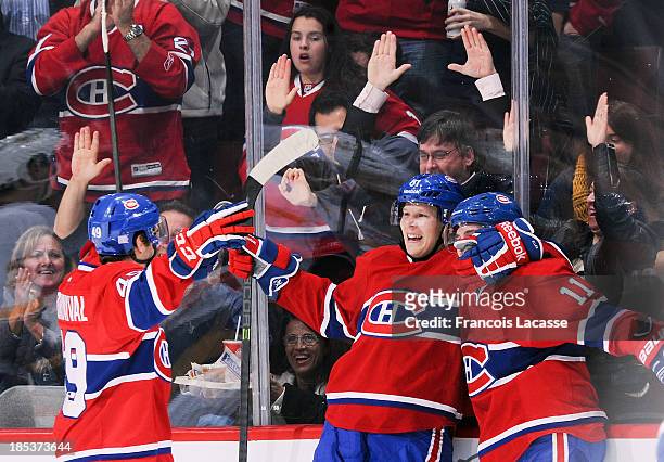 Michael Bournival, Lars Eller and Brendan Gallagher of the Montreal Canadiens celebrate after scoring a goal in the second period against the...