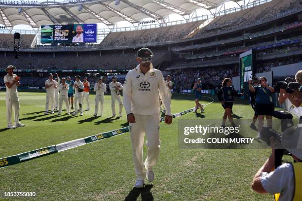 Australia's players applaud teammate Nathan Lyon , who took his 500th wicket, as they leave the field after their victory on day four of the first...