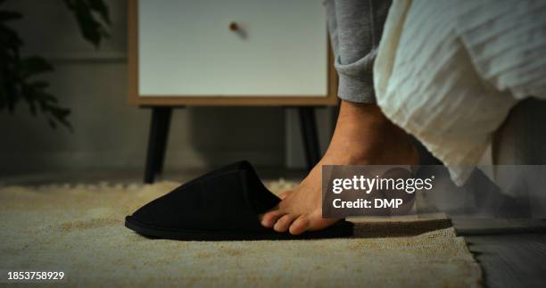 slippers, morning and feet of person by bed for routine to start day, getting ready and wake up. floor, home and closeup of comfortable, warm and soft shoes in bedroom for walking in apartment - chinelos imagens e fotografias de stock