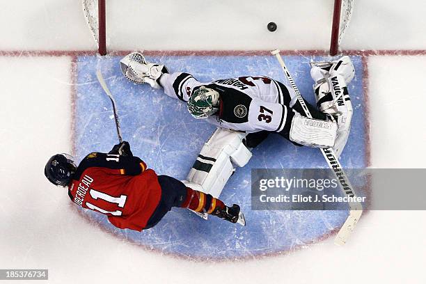 Jonathan Huberdeau of the Florida Panthers scores against goaltender Josh Harding of the Minnesota Wild in a shoot-out at the BB&T Center on October...