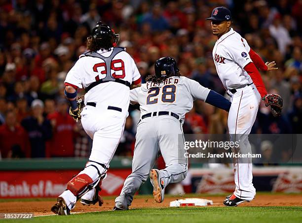 Prince Fielder of the Detroit Tigers falls to the ground and gets tagged out by Jarrod Saltalamacchia of the Boston Red Sox in the sixth inning...