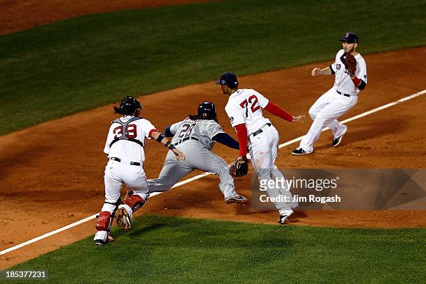 Prince Fielder of the Detroit Tigers falls to the ground and gets tagged out by Jarrod Saltalamacchia of the Boston Red Sox in the sixth inning...