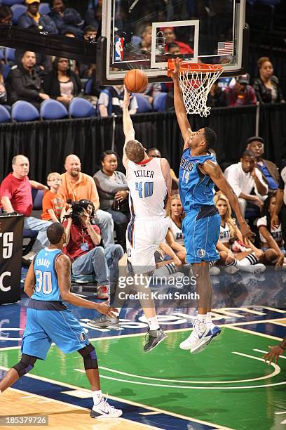 Cody Zeller of the Charlotte Bobcats drives against Fab Melo of the Dallas Mavericks at the Greensboro Coliseum on October 19, 2013 in Greensboro,...