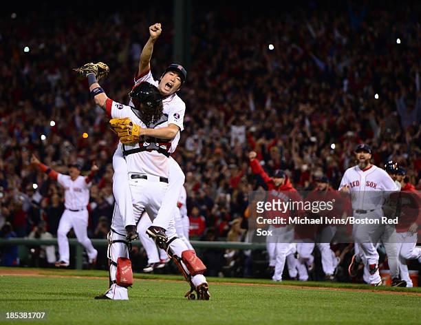 Koji Uehara of the Boston Red Sox jumps into the arms of Jarrod Saltalamacchia after defeating the Detroit Tigers in Game Six of the American League...