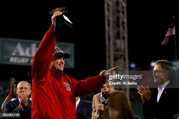 Manager John Farrell of the Boston Red Sox celebrates with the trophy after defeating the Detroit Tigers in Game Six of the American League...