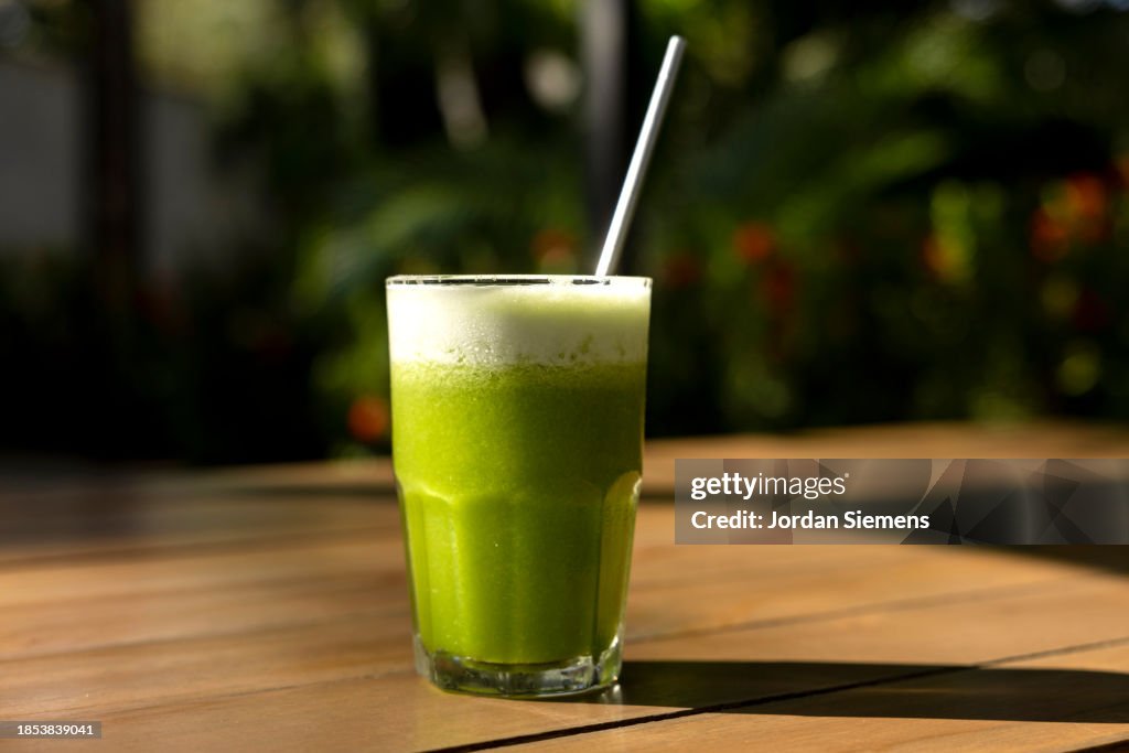 A green smoothie on a table.