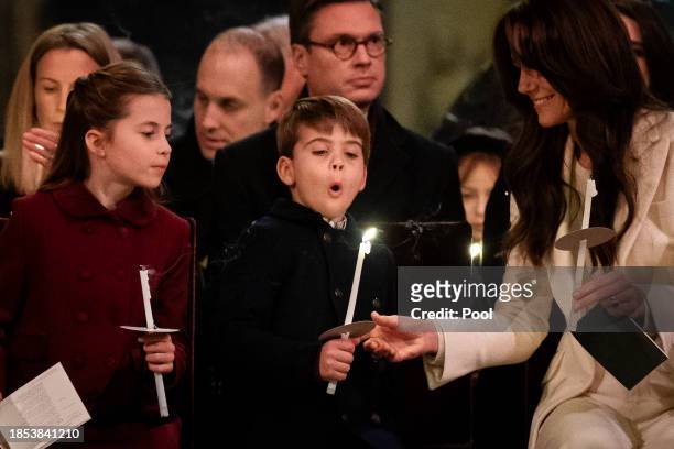 Princess Charlotte, Prince Louis blowing out his candle and Catherine, Princess of Wales during the Royal Carols - Together At Christmas service at...
