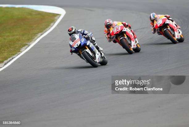 Jorge Lorenzo of Spain riding the Yamaha Factory Racing Yamaha is chased by Marc Marquez and Dani Pedrosa both of Spain and the Repsol Honda Team...