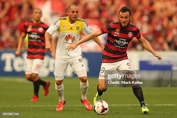 Leo Bertos of the Phoenix and Mark Bridge of the Wanderers compete for the ball during the round two A-League match between the Western Sydney...