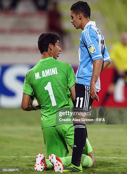 Goalkeeper Mahdi Amini of Iran is challenged by Marcos Astina of Argentina during the FIFA U-17 World Cup UAE 2013 Group E match between Iran and...