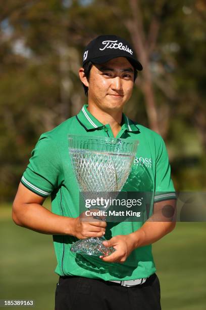 Jin Jeong of Korea holds aloft the winners trophy after winning a playoff against Ross Fisher of England during day four of the Perth International...