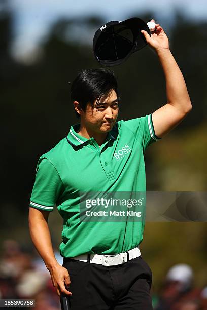 Jin Jeong of Korea acknowledges the crowd after putting on the 18th hole and forcing a playoff against Ross Fisher of England during day four of the...