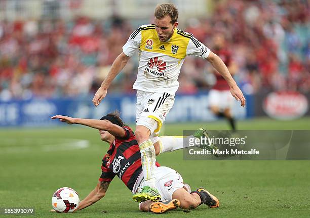 Jeremy Brockie of the Phoenix takes on Jerome Polenz of the Wanderers during the round two A-League match between the Western Sydney Wanderers and...