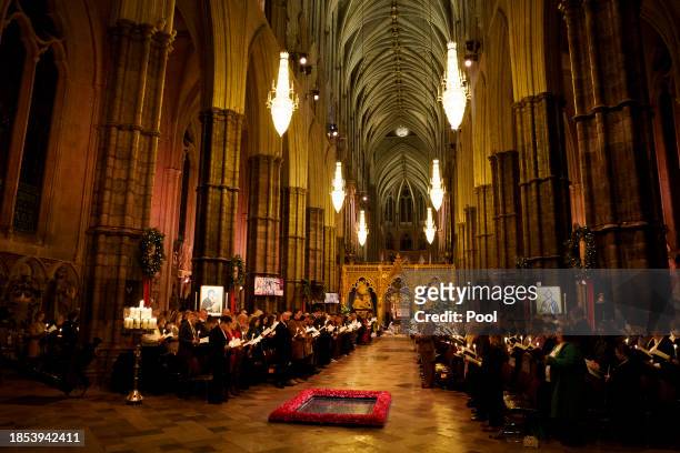 Members of the congregation hold candles during the Royal Carols - Together At Christmas service at Westminster Abbey on December 8, 2023 in London,...