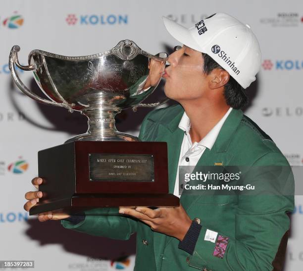 Kang Sung-Hoon of South Korea lifts the winner's trophy during a ceremony following the final round of the 56th Kolon Korea Open 2013 at the Woo...