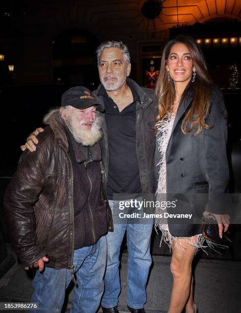 Radio Man, George Clooney and Amal Clooney arrive to the Polo Bar on December 13, 2023 in New York City.