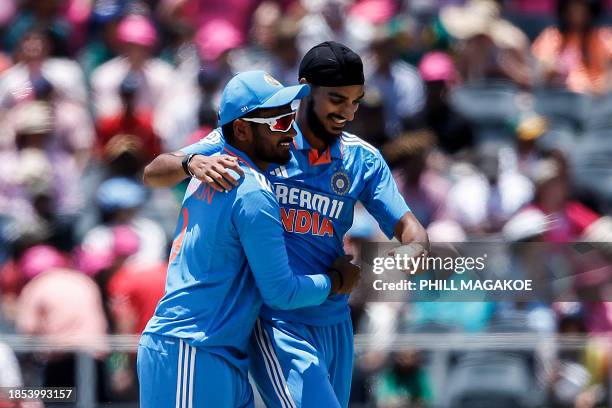 India's Arshdeep Singh celebrates with teammate Sanju Samson his ODI five wicket maiden during the 1st ODI cricket match between South Africa and...