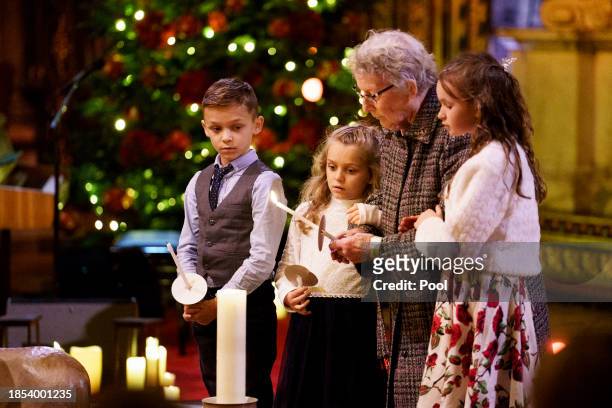 Guests light candles during the Royal Carols - Together At Christmas service at Westminster Abbey on December 8, 2023 in London, England.