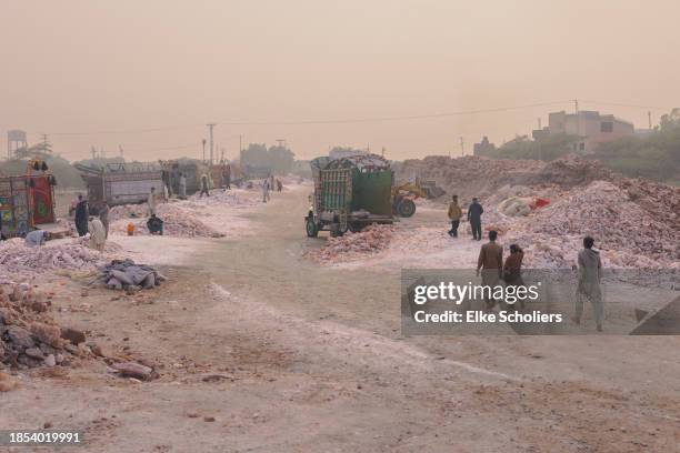 Workers load industrial salt at the Khewra salt mine on December 12, 2023 in Jhelum, Pakistan. Accounting for roughly 800 million pounds of salt each...