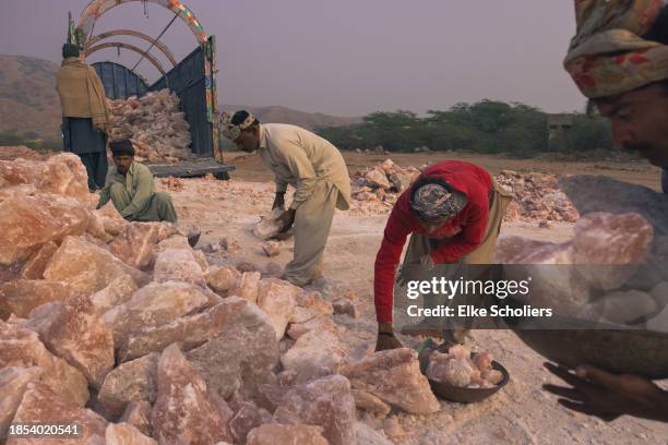 Workers load industrial salt at the Khewra salt mine on December 12, 2023 in Jhelum, Pakistan. Accounting for roughly 800 million pounds of salt each...