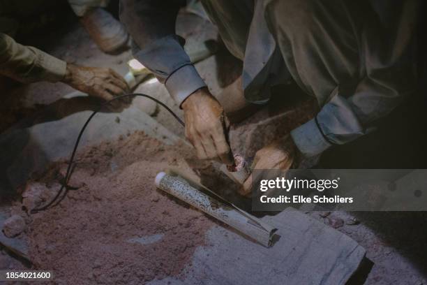 Workers showcase how to make an explosion in the Khewra salt mine on December 12, 2023 in Jhelum, Pakistan. Accounting for roughly 800 million pounds...