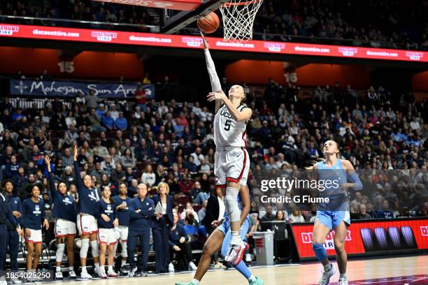 Paige Bueckers of the UConn Huskies drives to the basket against the North Carolina Tar Heels at Mohegan Sun Arena on December 10, 2023 in...