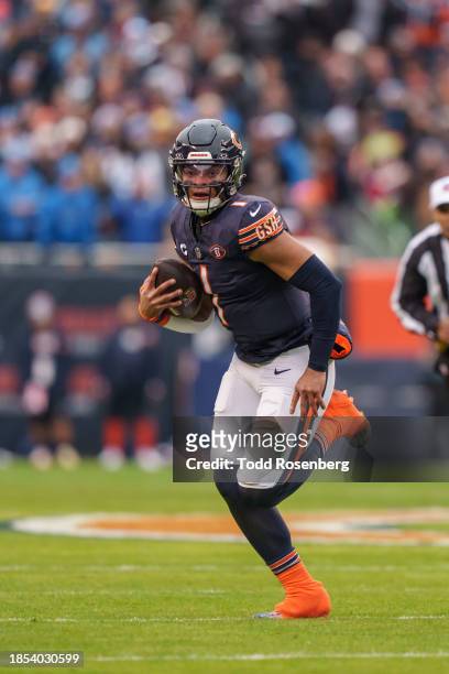 Quarterback Justin Fields of the Chicago Bears runs the ball during an NFL football game against the Detroit Lions at Soldier Field on December 10,...