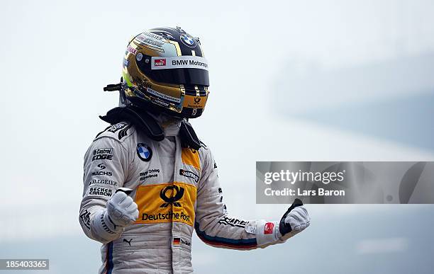 Timo Glock of Germany and BMW Team MTEK celebrates after winning during the final round of the DTM 2013 German Touring Car Championship at...