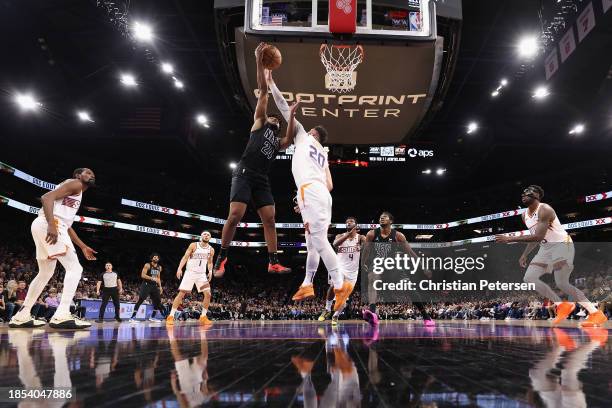 Cam Thomas of the Brooklyn Nets puts up a shot over Jusuf Nurkic of the Phoenix Suns during the first half of the NBA game at Footprint Center on...