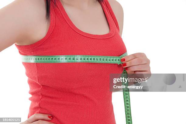 young woman is measuring her breast - grote borsten stockfoto's en -beelden