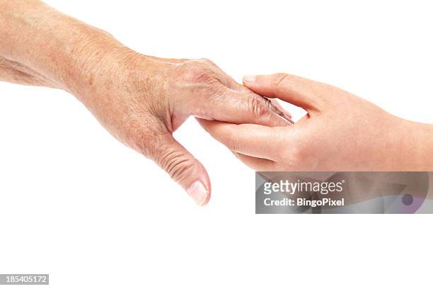 hands of young and senior women - helping - handshake isolated stock pictures, royalty-free photos & images