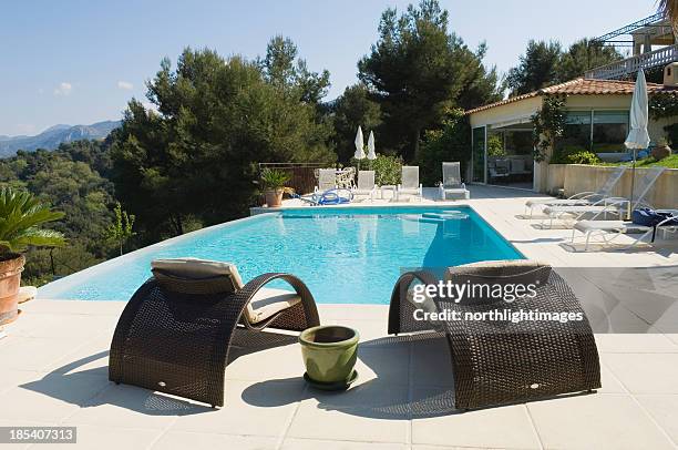 seats by the pool - south france stock pictures, royalty-free photos & images