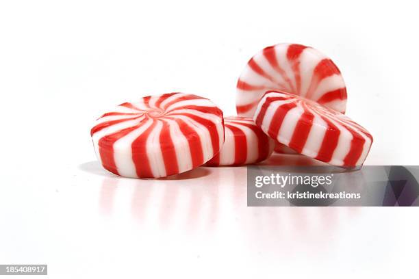 a picture of four peppermint candies on a white background - mint sweet stock pictures, royalty-free photos & images