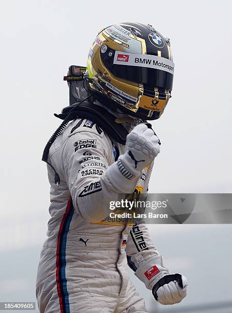 Timo Glock of Germany and BMW Team MTEK celebrates after winning during the final round of the DTM 2013 German Touring Car Championship at...