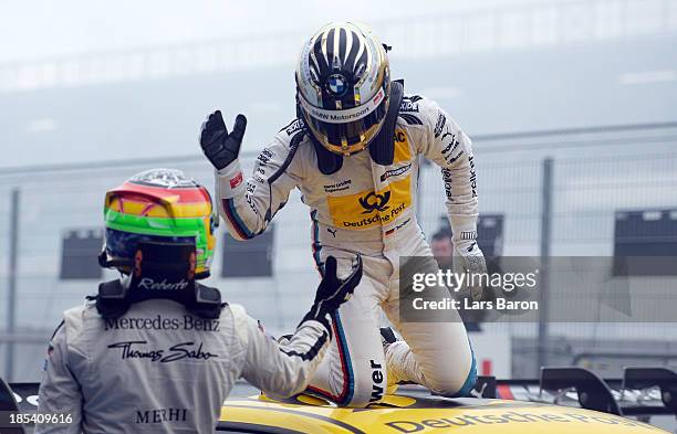 Timo Glock of Germany and BMW Team MTEK celebrates with second placed Roberto Merhi of Spain and THOMAS SABO Mercedes AMG after winning during the...