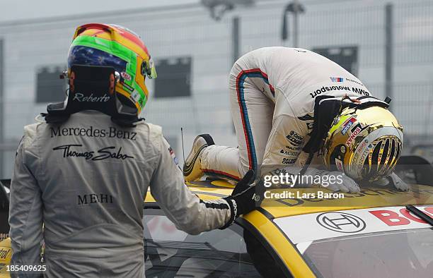 Timo Glock of Germany and BMW Team MTEK celebrates with second placed Roberto Merhi of Spain and THOMAS SABO Mercedes AMG after winning during the...