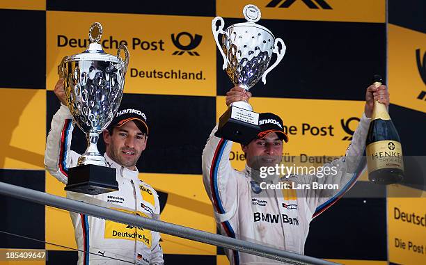 Timo Glock of Germany and BMW Team MTEK celebrates with third placed Bruno Spengler of Canada and BMW Team Schnitzer after winning during the final...