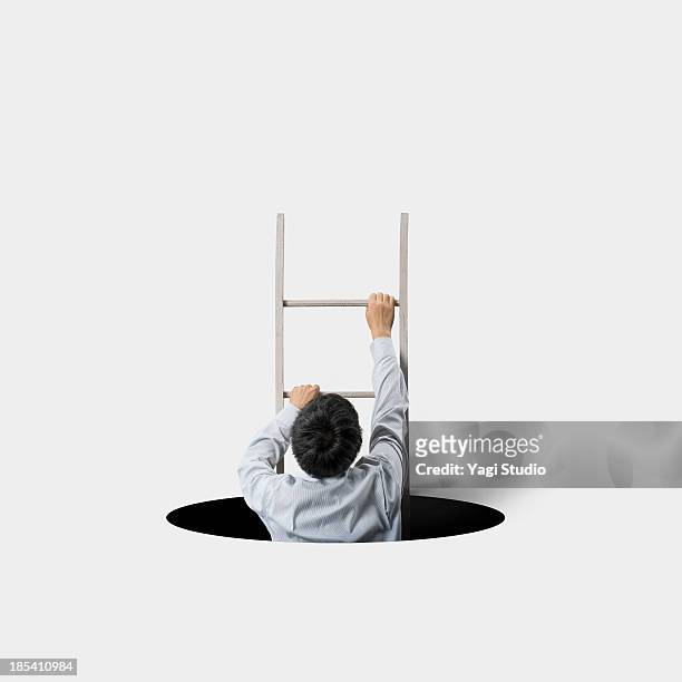 the man climbing the ladder - moving up the ladder stock pictures, royalty-free photos & images