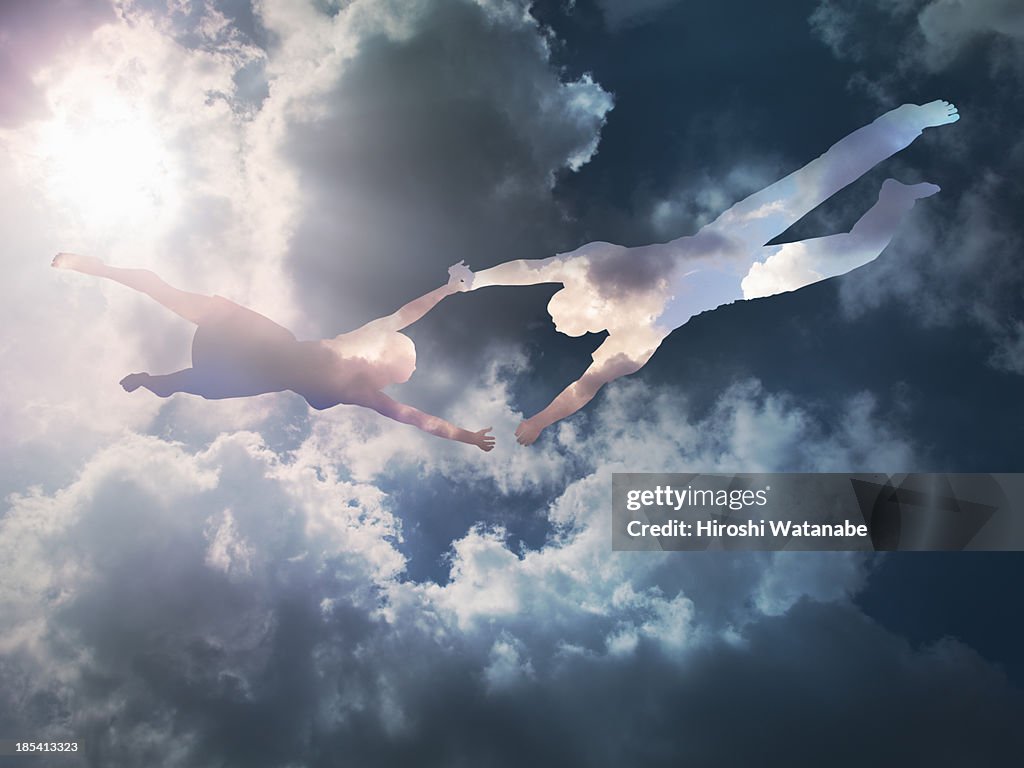 The couple made of clouds are flying in the sky