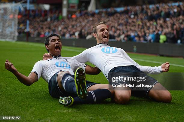 Roberto Soldado of Spurs celebrates scoring their second goal with Paulinho of Spurs during the Barclays Premier League match between Aston Villa and...