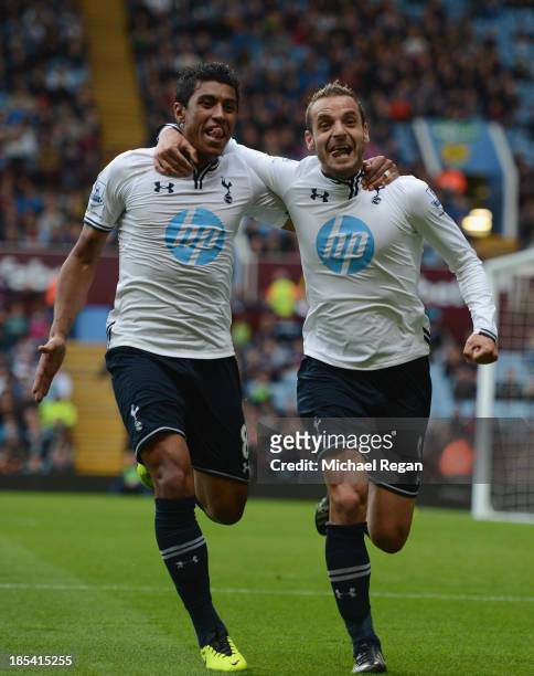Roberto Soldado of Spurs celebrates scoring their second goal with Paulinho of Spurs during the Barclays Premier League match between Aston Villa and...