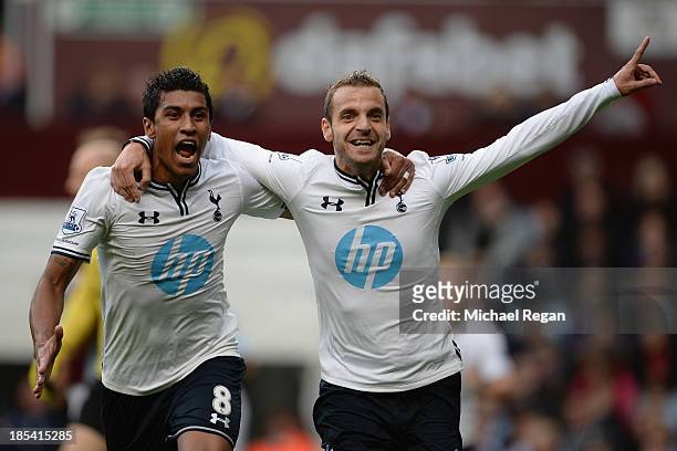 Roberto Soldado of Spurs celebrates scoring their second goal with Paulinho of Spurs during the Barclays Premier League match between Aston Villa and...