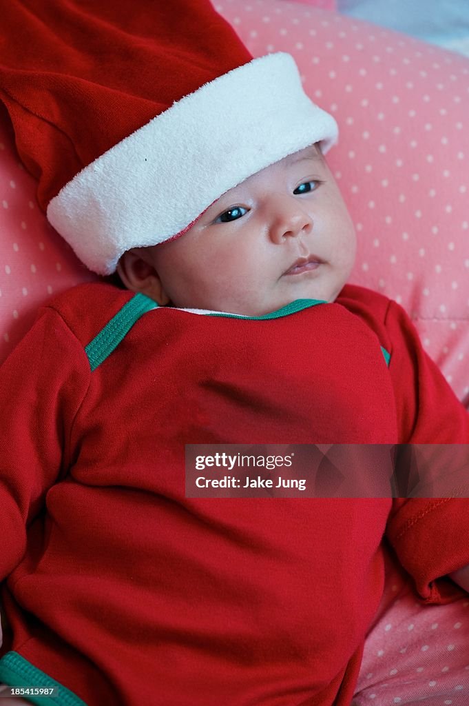 Newborn baby girl in red Christmas outfit