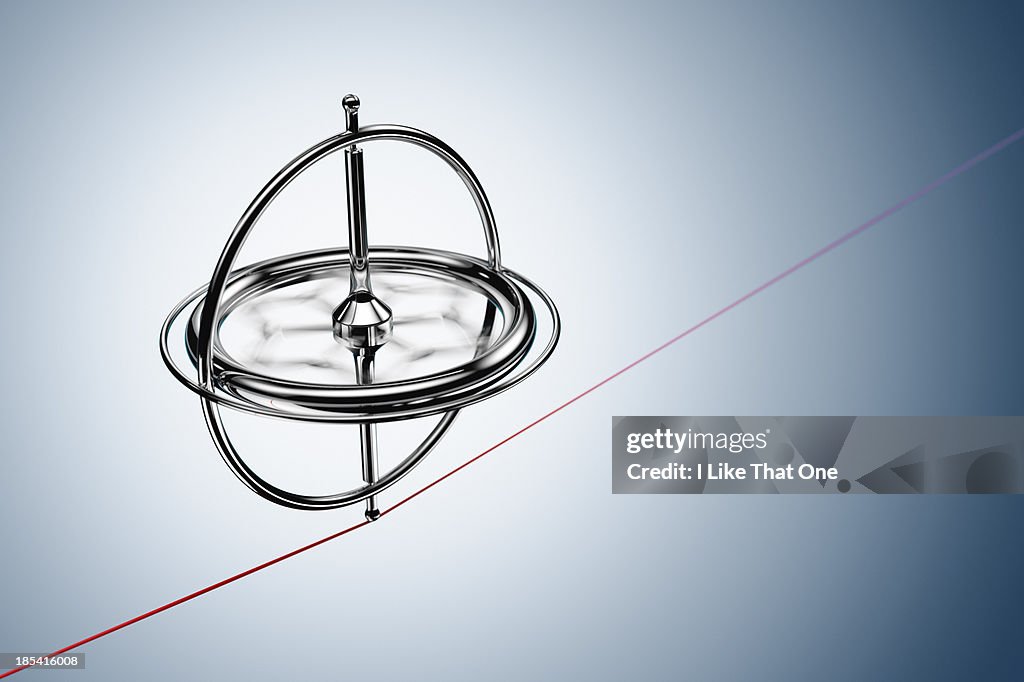 Spinning gyroscope, balancing on a red cable